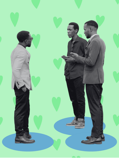 A black and white image of three men wearing suits standing and talking with each other.